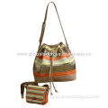 Women's straw drawstring bag in metallic effect strips, suitable for summer outing